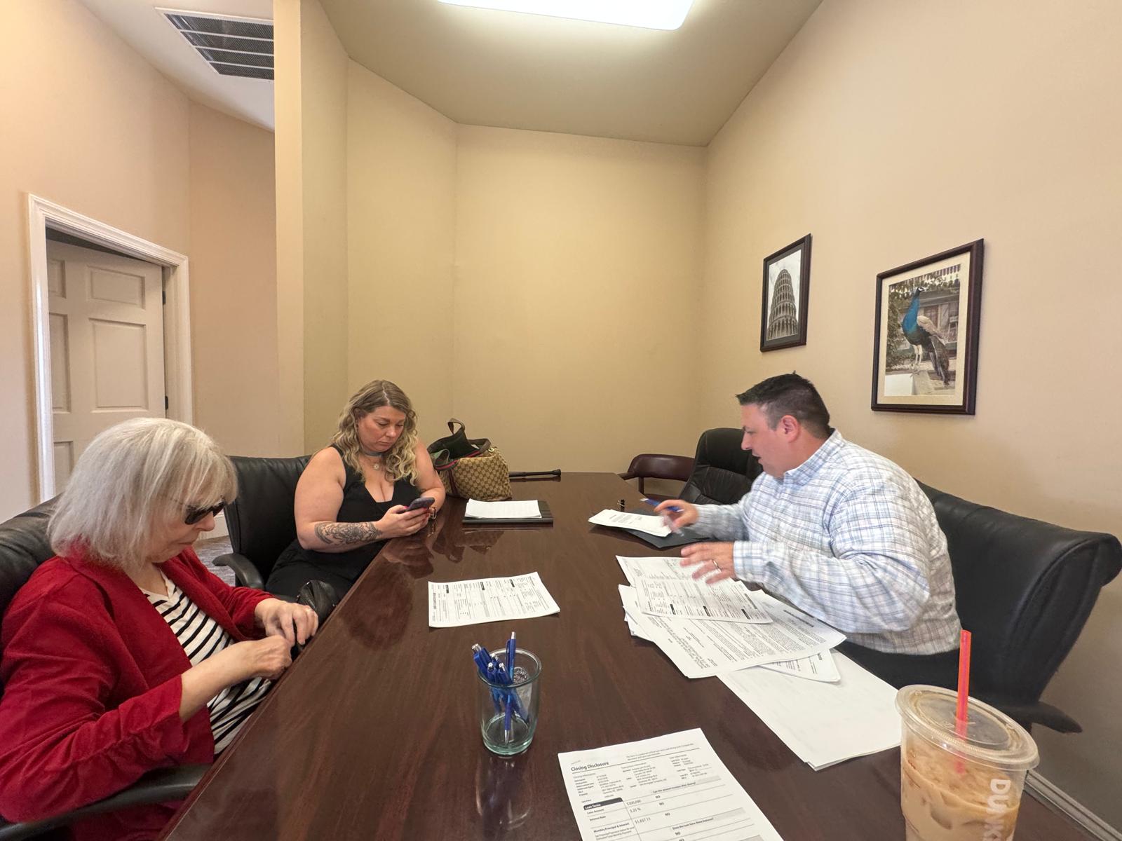 Jeannie Alvear reviewing documents with clients
