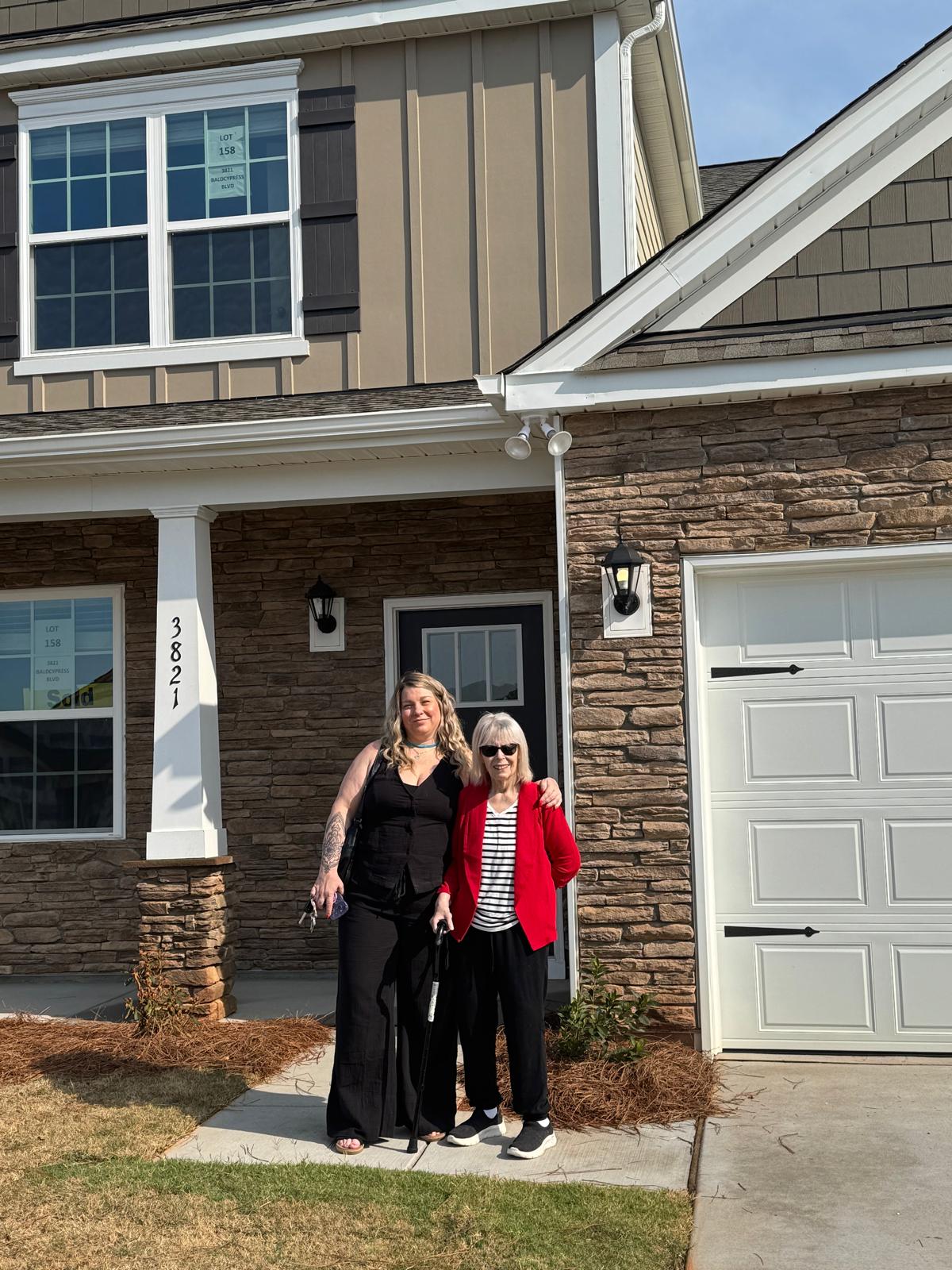 Jeannie Alvear close up with client at new construction sold home