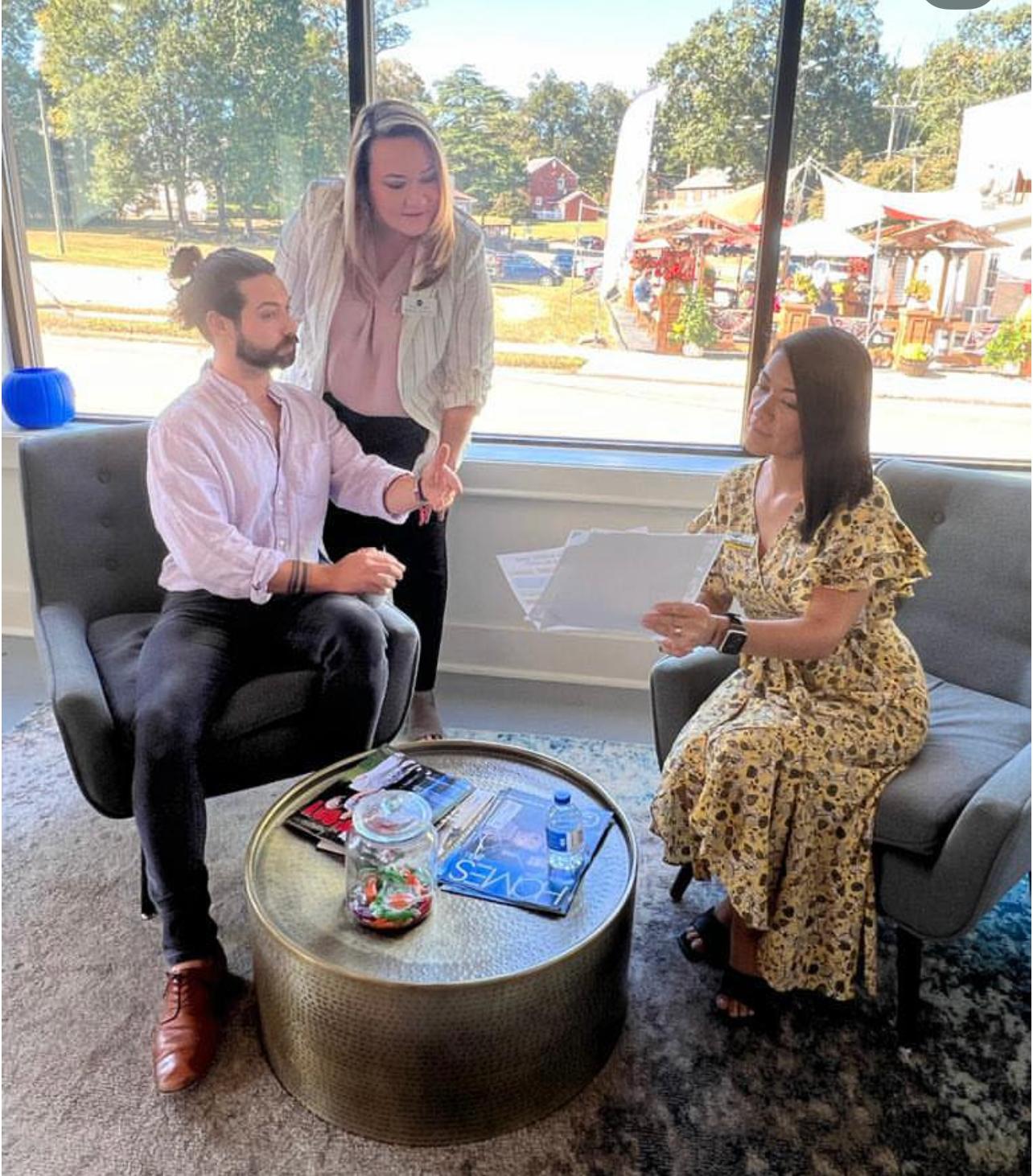Jeannie and Sandy Alvear consulting with clients in office