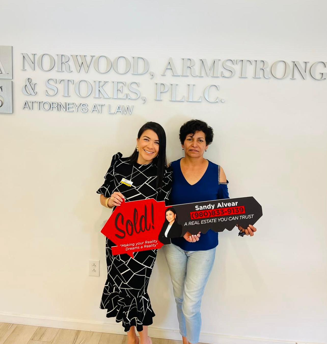 Sandy Alvear with clients at Norwood Armstrong Stokes closing
