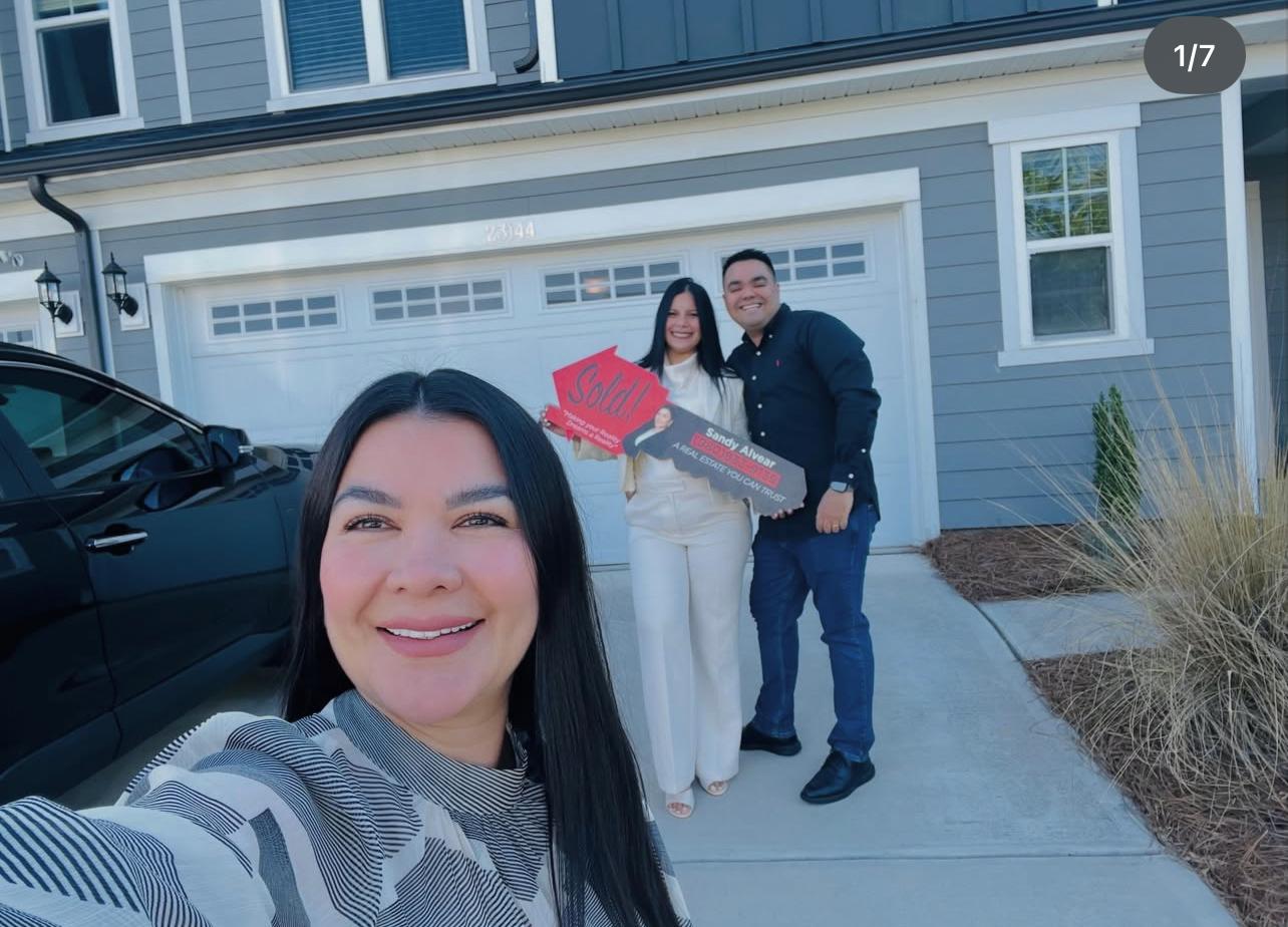 Sandy Alvear with happy clients at their new home — Belmont NC